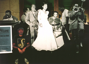 Life-sized all-star cut-out jazz septet jams onstage as “Jazz” exhibit designer/co-curator sits in, UT Austin, 2004. Life-sized all-star cut-out jazz septet jams onstage as “Jazz” exhibit designer/co-curator sits in, UT Austin, 2004.